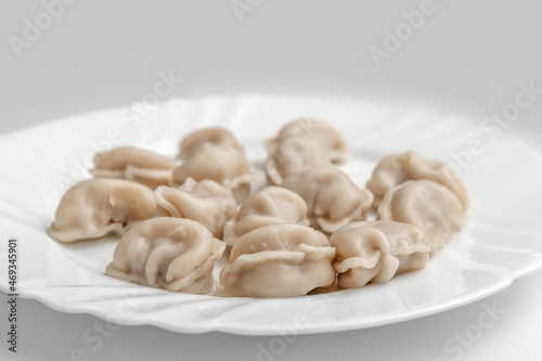 Pelmeni. Meat dumplings on a white plate. Good nutrition. Healthy food. Photo