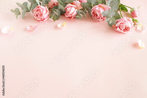 Flowers background.Pink roses  and eucalyptus branch bouquet frame top view o...