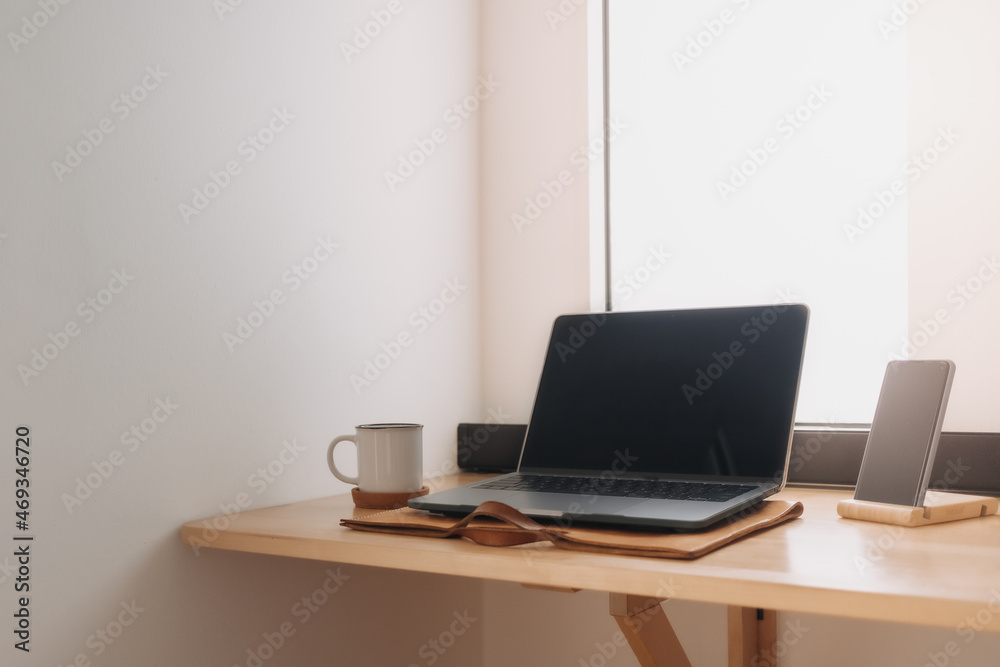 Laptop workspace on wooden desk by the windows with morning light. Laptop workspace on wooden desk by the windows with morning light.