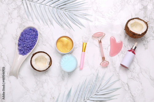 A set of cosmetics and cosmetic tools on a marble background. Top view. Flat lay