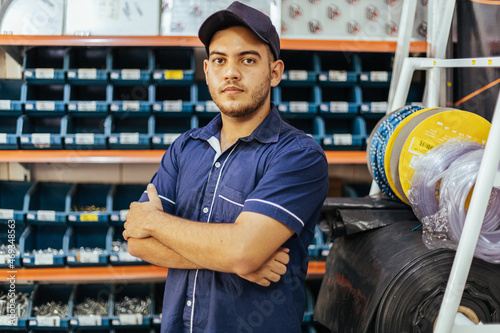 Young latin man working in hardware store photo