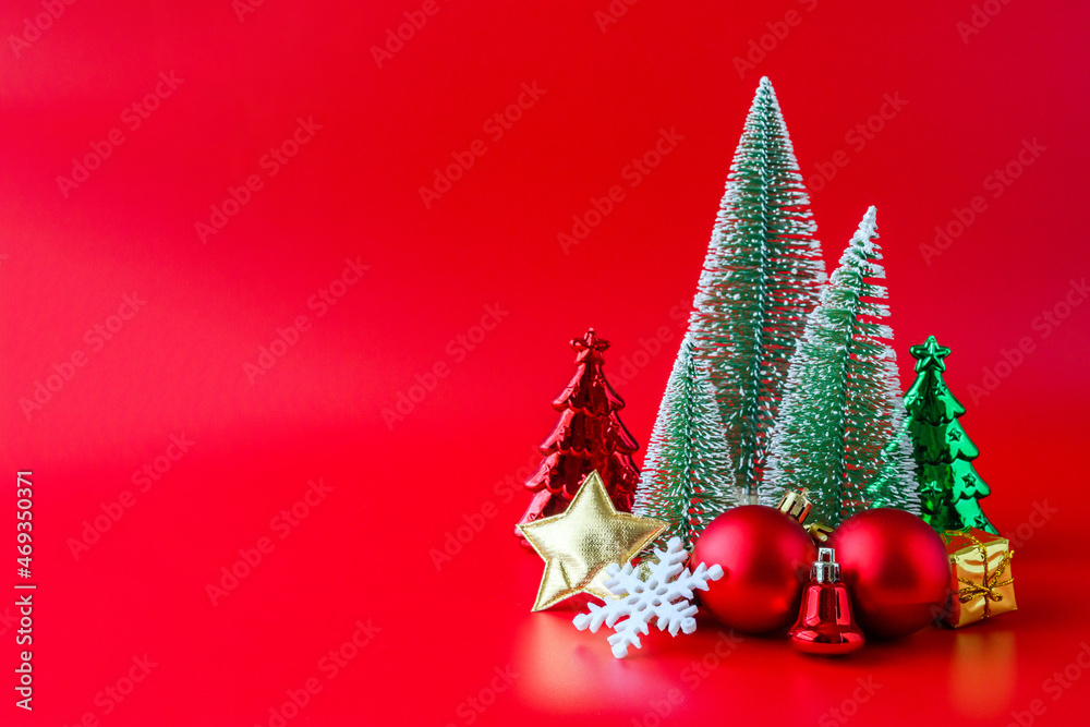 Christmas tree and baubles on red background new year  holiday celebration concept