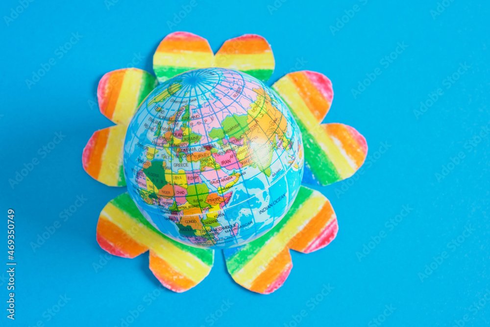 toy ball in the form of a planet and several hearts painted in the colors of the lgbtq community, pride concept