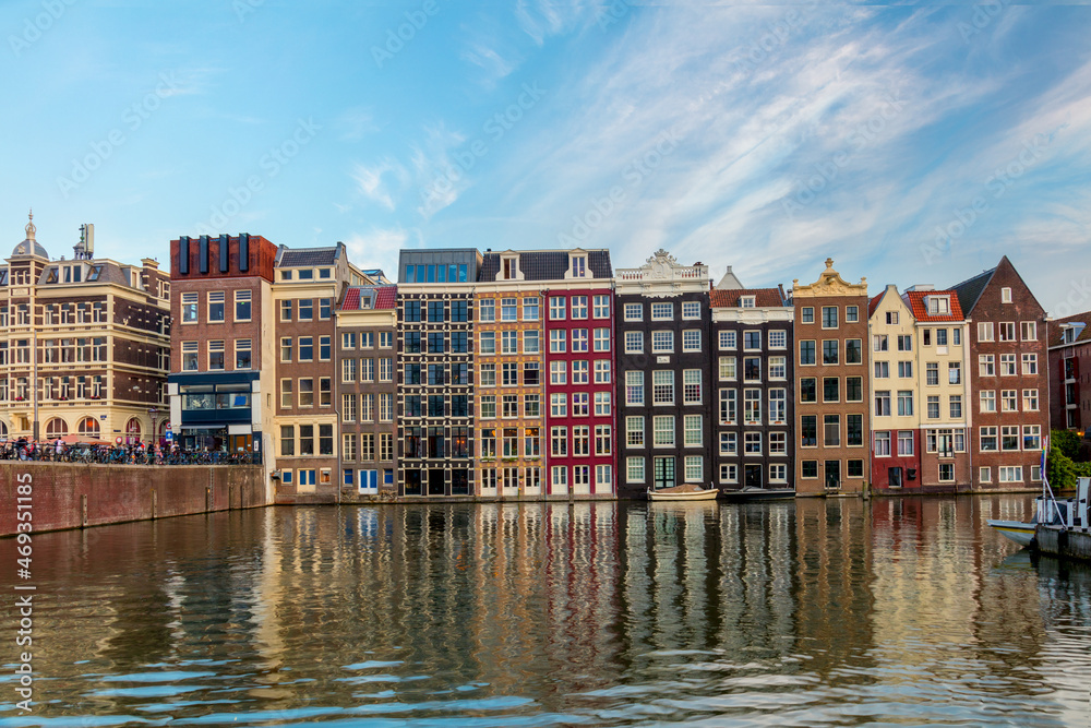 Amsterdam Houses. The houses stand in the water and have a beautiful reflection. Touristic district Damrak. These houses are famous all over the world. Amsterdam, Holland, Europe