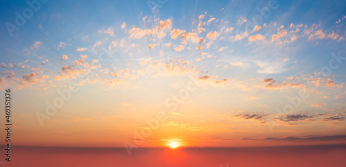 Majestic panoramic view of the sunrise in the morning sky. Light gentle clouds. Sundown Natural sky