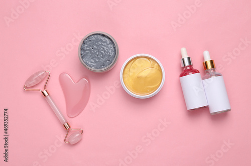 Set for facial care on a pink background. Flat lay beauty composition. Skin care, lifting face concept