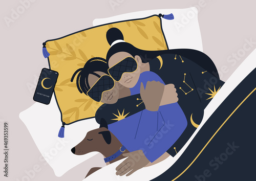 A top view of an interracial couple sleeping with their pet, a cozy home atmosphere