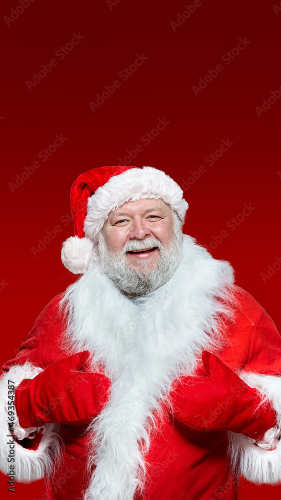 Closeup of a happy Santa Claus in a red coat, gloves and a hat, with his hands raised high, isolated red background. Closeup of a happy Santa Claus in a red coat, gloves and a hat, with his hands raised high, isolated red background.