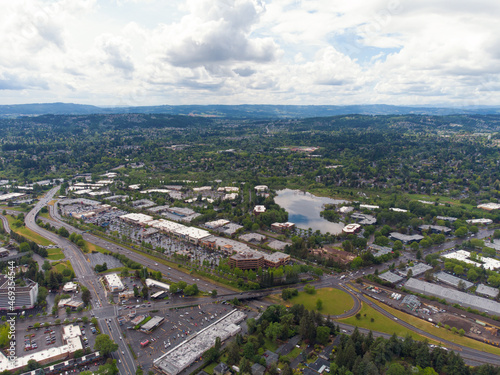 Aerial photograph. Small town. Lots of greenery, mountains, lake, well-developed infrastructure, asphalt roads. Beauty of nature. Ecology, geology, social and housing issues.