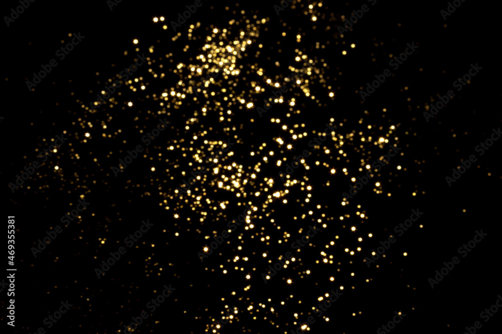 Golden blurred bokeh lights on black background. Glitter sparkle stars for celebrate. Overlay for your design Golden blurred bokeh lights on black background. Glitter sparkle stars for celebrate. Overlay for your design