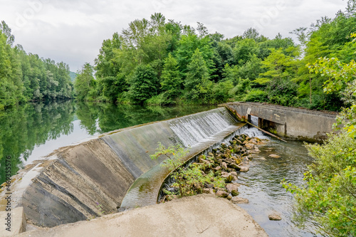 Small hydroelectric power plant in the river, France. Operating since the 60s. High quality photo