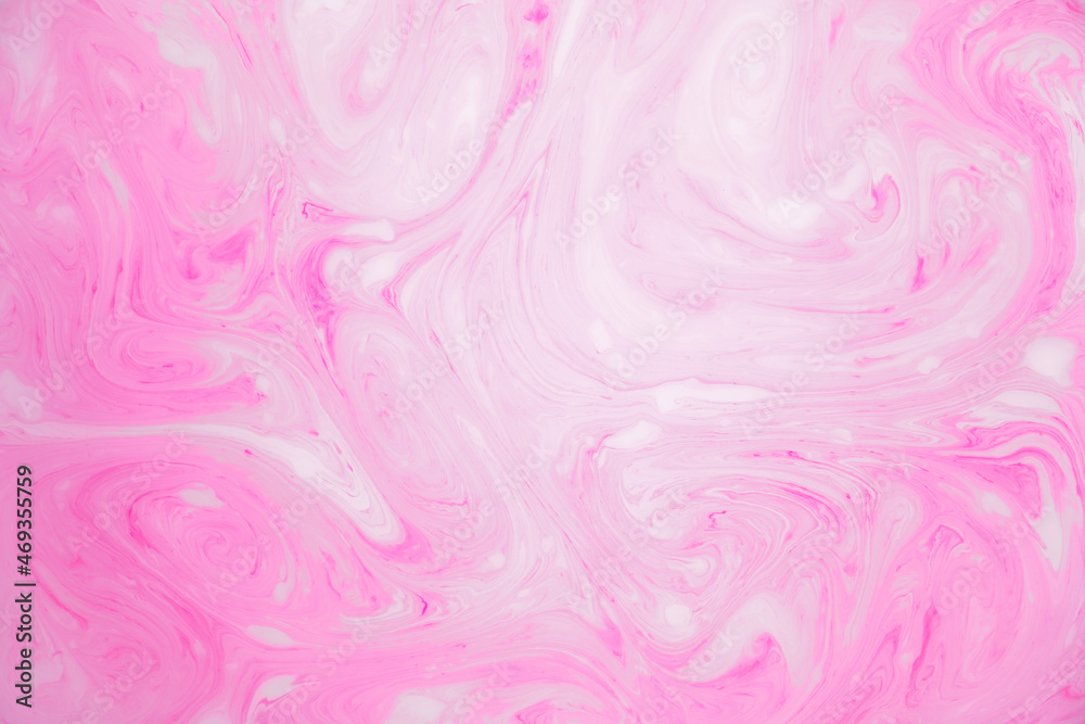 Abstract colored marble background, stains of pink paint on the surface of the water. Liquid colorful backdrop.