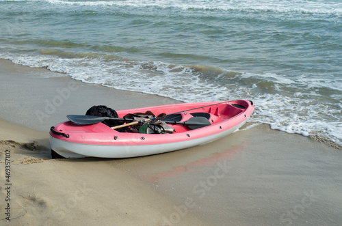 Red and white sea tandem kayak on beach