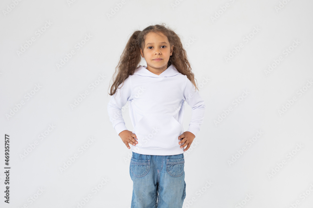 Little girl with two ponytails in a white hoodie. Mock-up. Little girl with two ponytails in a white hoodie. Mock-up.