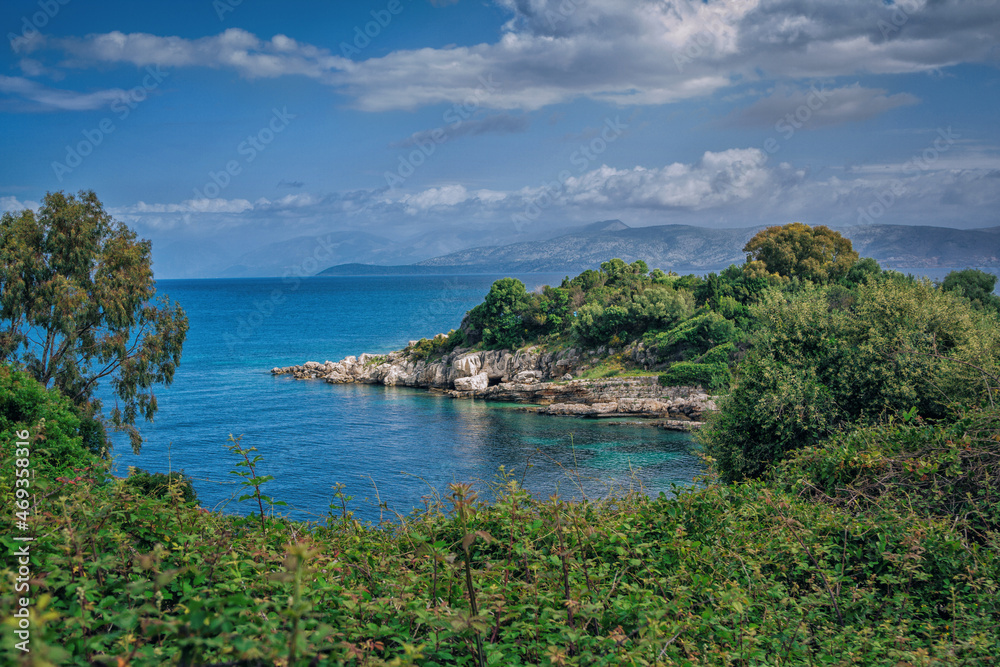 Beautiful landscape - sea bay with turquoise water, rocks and cliffs, green trees and bushes. Corfu Island, Greece.