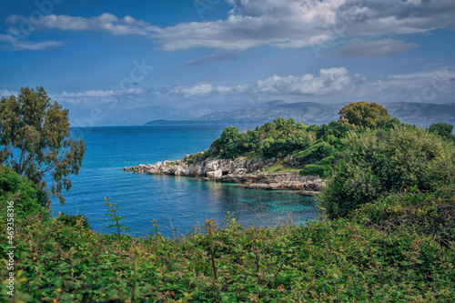 Beautiful landscape - sea bay with turquoise water, rocks and cliffs, green trees and bushes. Corfu Island, Greece.