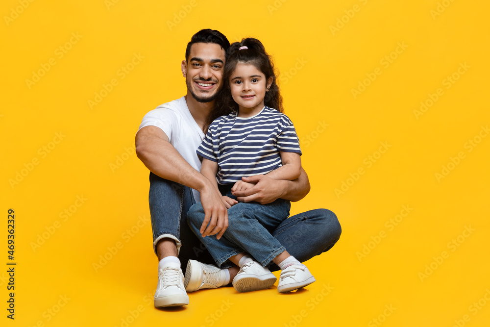 Portrait Of Happy Young Arab Father With His Cute Little Daughter