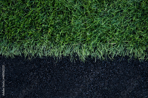 Artificial grass arena with finely ground black rubber. Texture of a rubber treadmill