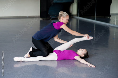 Healthy life education by example - woman and little girl exercising together