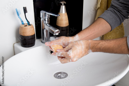 man washing his hands with plenty of foam due to the covid-19 pandemic