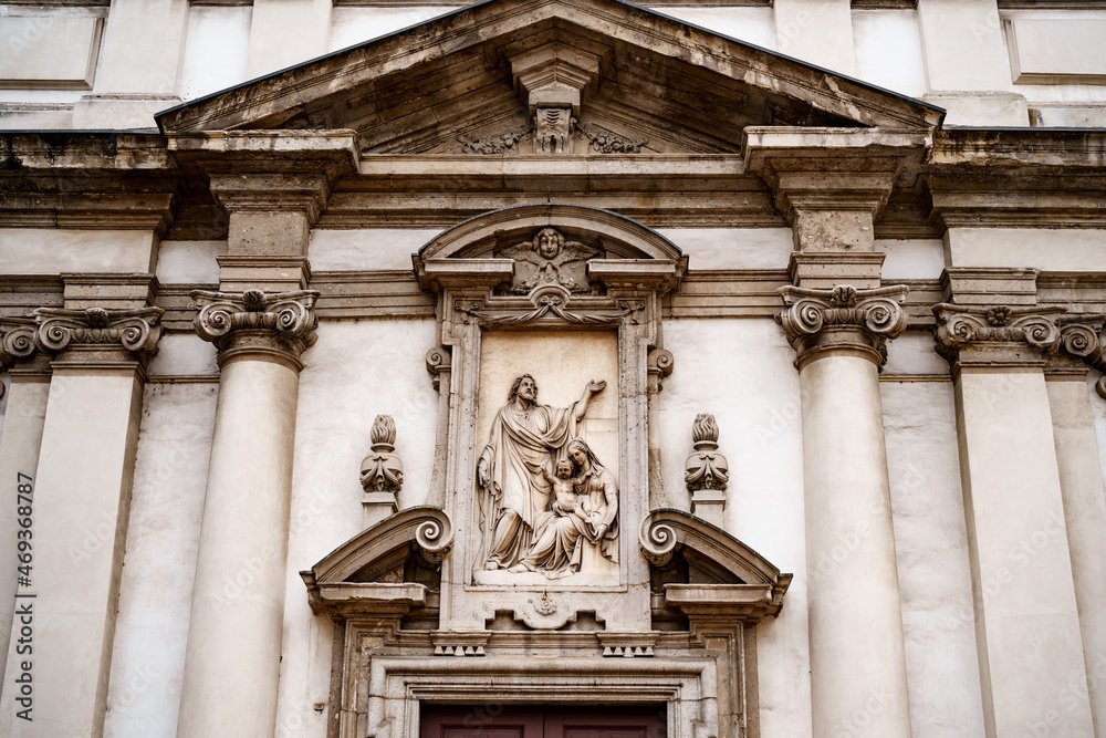 Stucco molding and bas-relief above the entrance to the Church of San Giuseppe. Milan, Italy