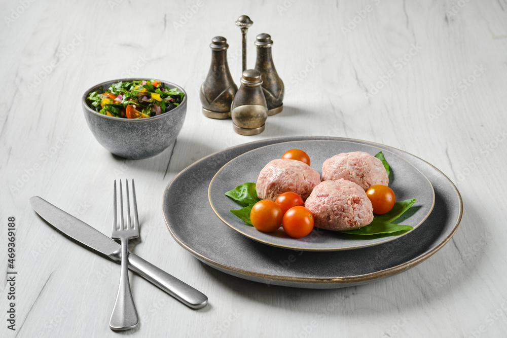 Semifinished frozen veal meatballs on a plate Semifinished frozen veal meatballs on a plate