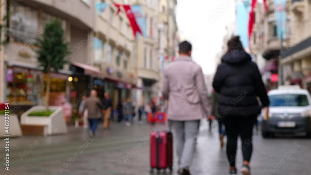 Unrecognizable tourists walk down the street paved pedestrian street in the morning. People at Istiklal Caddesi, Istanbul, Turkey. Defocused video footage Unrecognizable tourists walk down the street paved pedestrian street in the morning. People at Istiklal Caddesi, Istanbul, Turkey. Defocused video footage