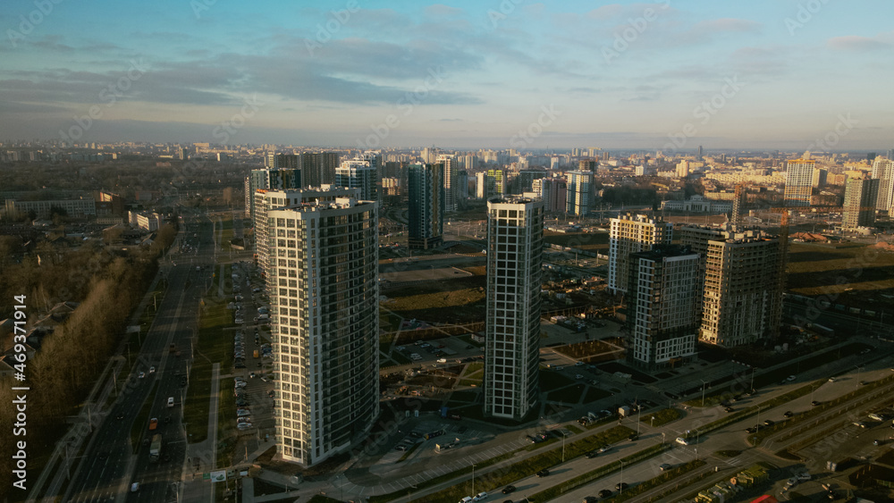 Fototapeta premium Construction site. Construction of modern multi-storey buildings. Against the background of the blue sky. Aerial photography.