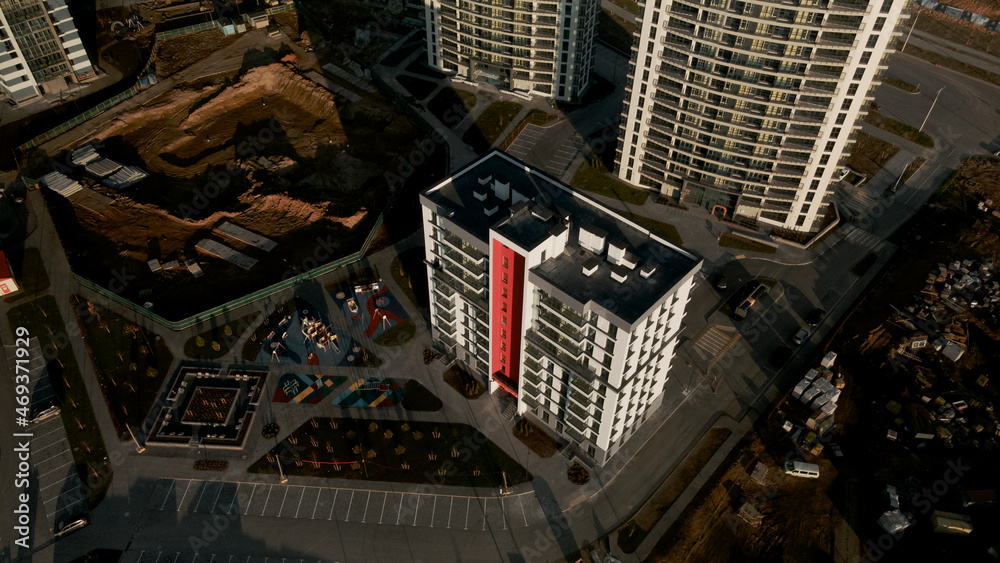 Construction site. Construction of modern multi-storey buildings. Against the background of the blue sky. Aerial photography.