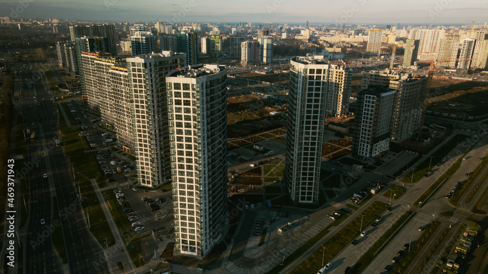 Obraz premium Construction site. Construction of modern multi-storey buildings. Against the background of the blue sky. Aerial photography.