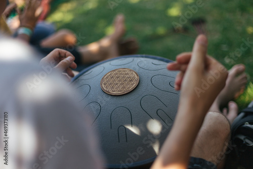 a man playing on tongue metal drums in the park