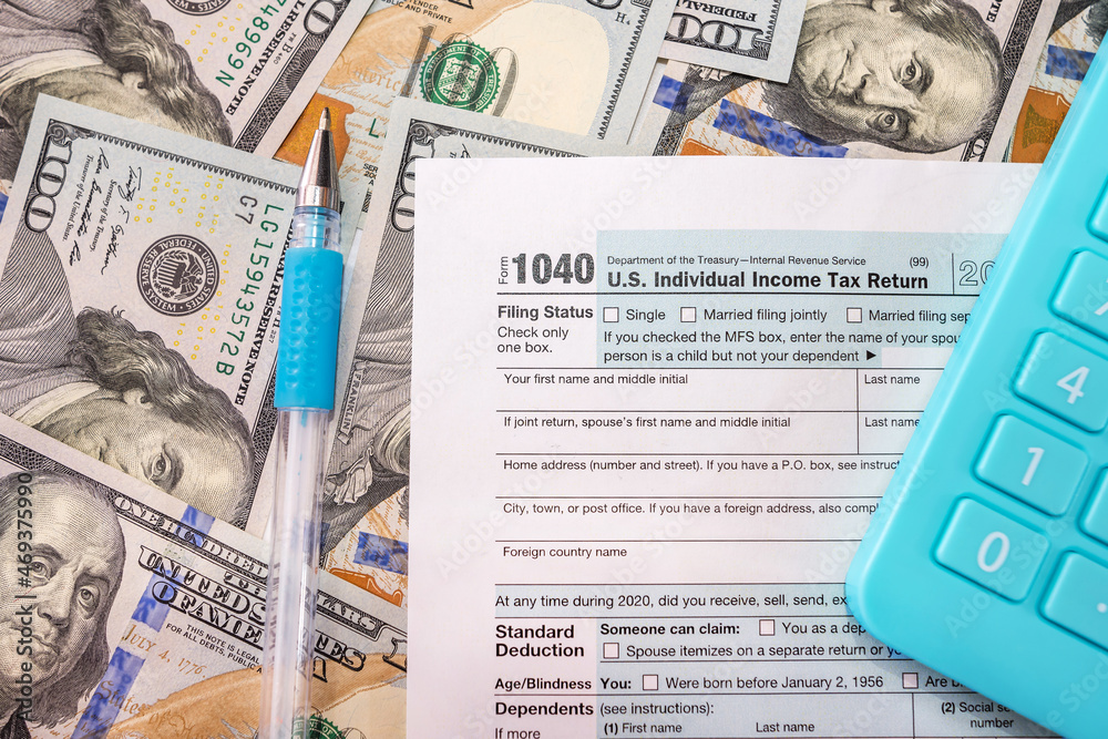 Obraz premium tax forms 1040, blue calculator and pen