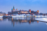 Krakow winter, night Wawel Castle over Vistula river, snow, Poland