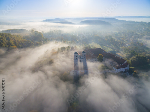 Aerial view of Tyniec abbey in Krakow, morning fog illuminated by the sun