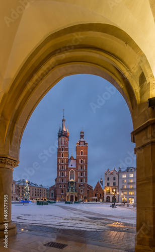 St Mary's church on snow covered Main Square in winter Krakow, illuminated in the night