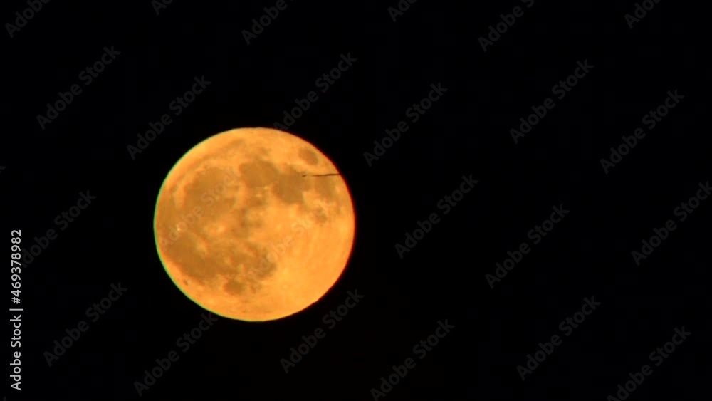 Timelapse full moon over late and plane passing in front, evening sky, France, High quality 4k footage Timelapse full moon over late and plane passing in front, evening sky, France, High quality 4k footage