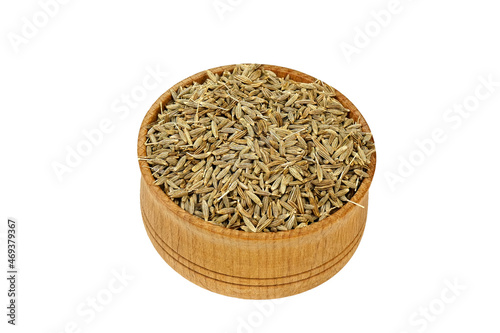Dry cumin seeds or zira spices from wooden spice jar, for preparation savory tasty food..
