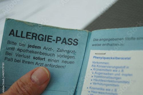 Frau hält ihren Allergie Pass in den Händen photo