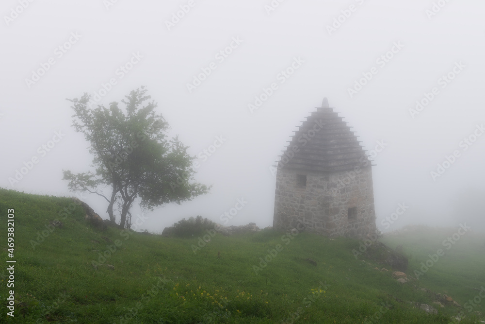 High-altitude medieval necropolis. It was a rainy and foggy morning in the Caucasus Mountain.