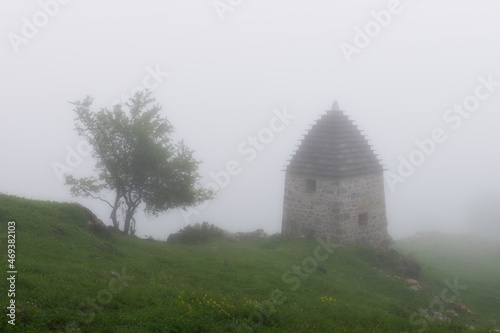 High-altitude medieval necropolis. It was a rainy and foggy morning in the Caucasus Mountain.