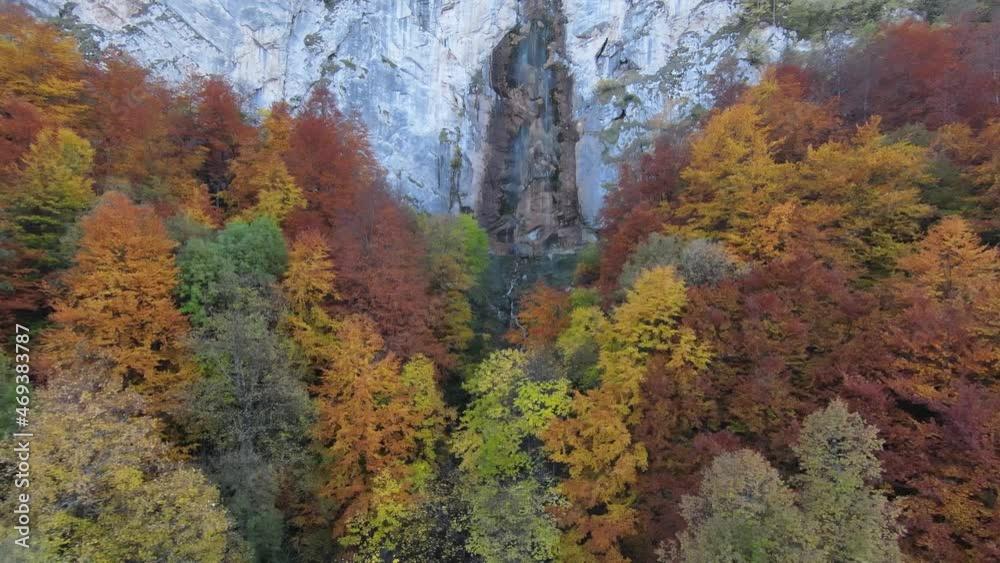 4K aerial view of autumn, waterfall, flying over forest in the autumn, big stones in the river, waterfall with big stones, blue sky 4K aerial view of autumn, waterfall, flying over forest in the autumn, big stones in the river, waterfall with big stones, blue sky