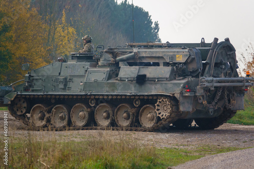 close up full-side view of a British Army Challenger Armored Repair and Recovery Vehicle (CRARRV) in action on a military training exercise, salisbury plain wiltshire UK