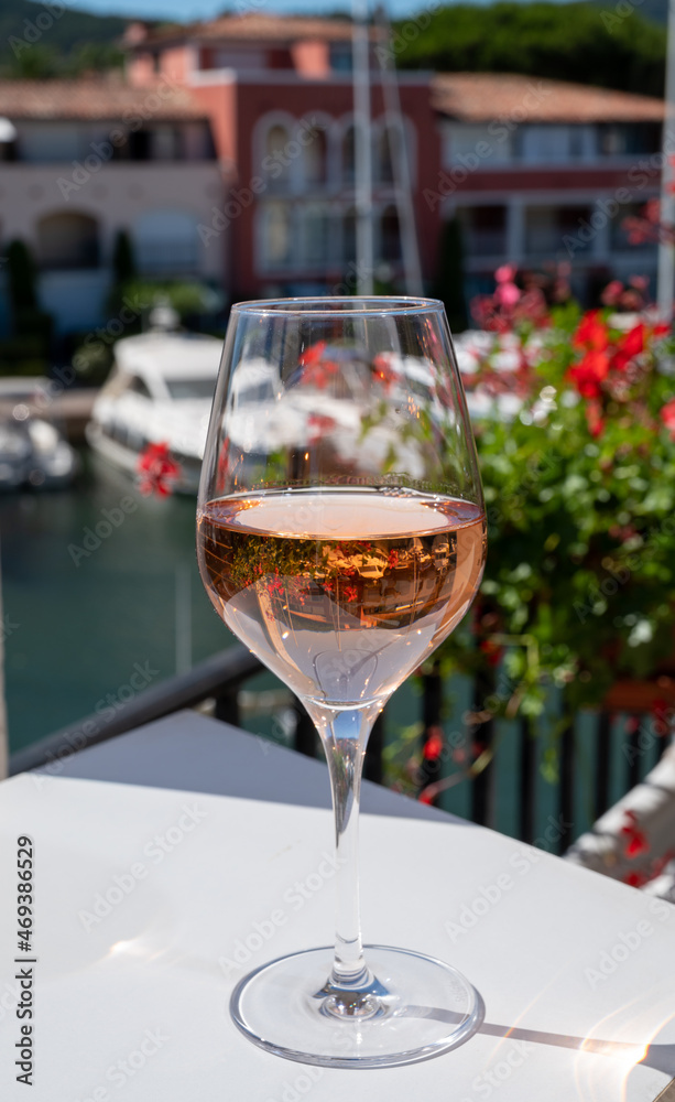 Summer on French Riviera Cote d'Azur, drinking cold rose wine from Cotes de Provence on outdoor terrase in Port Grimaud, Var, France Summer on French Riviera Cote d'Azur, drinking cold rose wine from Cotes de Provence on outdoor terrase in Port Grimaud, Var, France