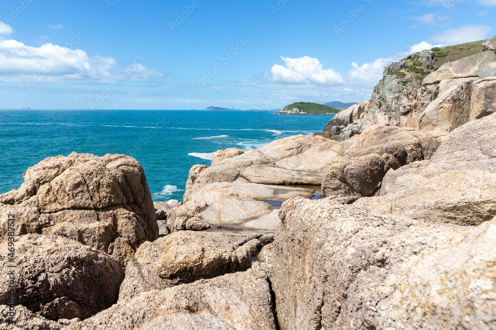 Rocks on cliffs and ocean in background