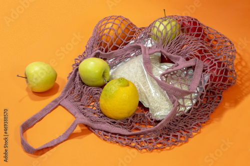 Healthy foods in a bag on an orange background