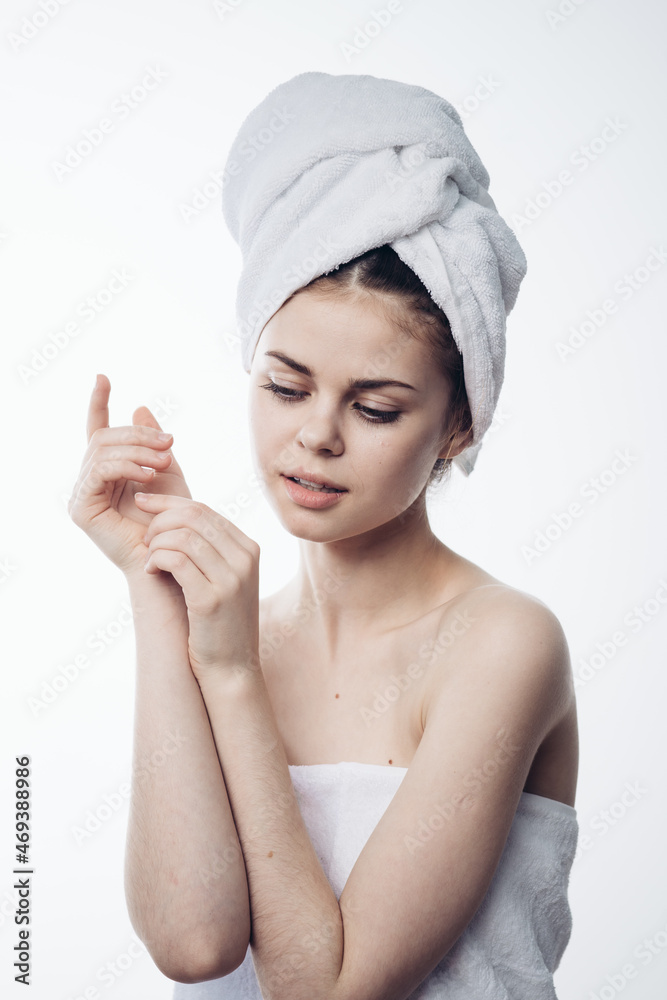 woman after shower with towel on head posing skin care