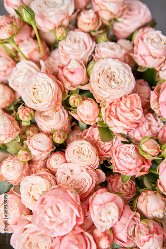 Floral carpet, flower texture, shop concept. Beautiful fresh blossoming flowers roses, spray roses. Blossom in vases and pails. Top view.