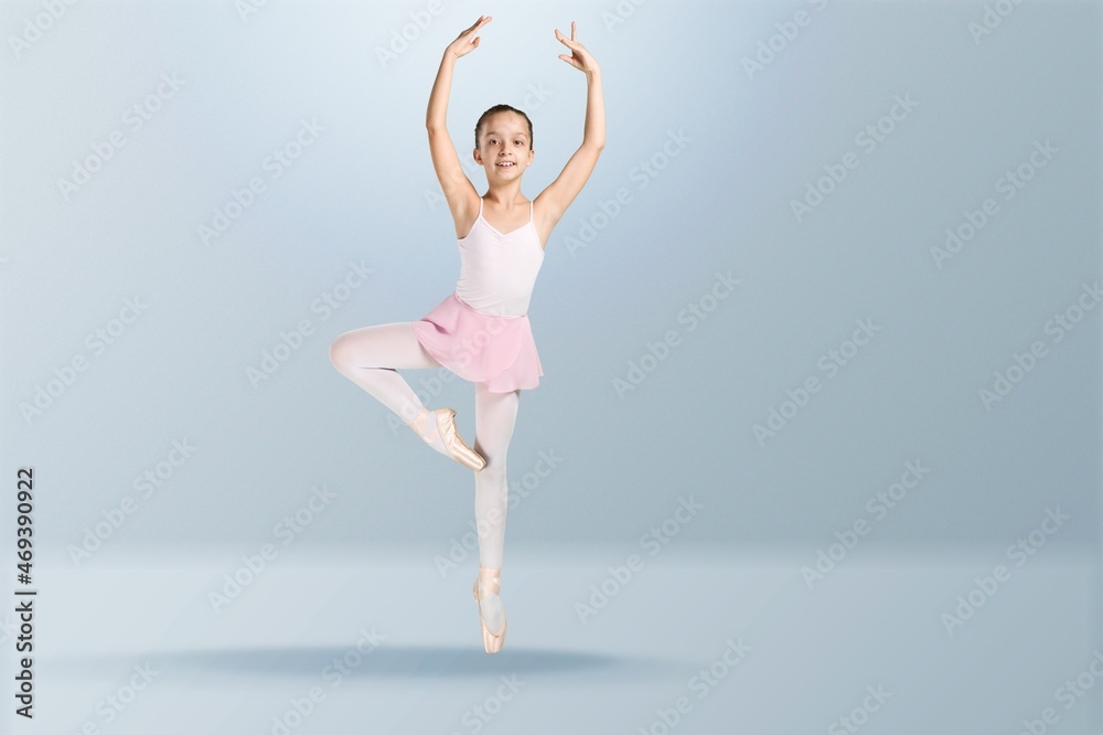 Tips on toes. Young graceful ballerina dancing alone on background.