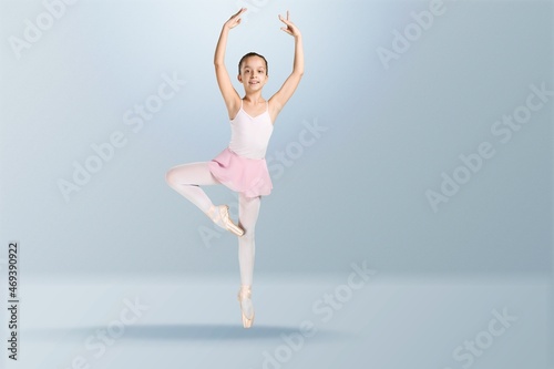 Tips on toes. Young graceful ballerina dancing alone on background. © BillionPhotos.com