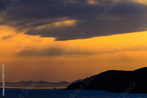 Picturesque islands in the Sea of Japan during a bright sunset. Beautiful seascape. © alexhitrov